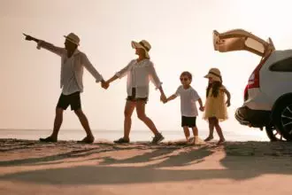 Asian family on the beach.Vacation time. Happy father, mother and son enjoying road trip