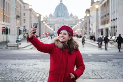 Selfie of young woman in Rome, Italy. Taking pictures with your smartphone.