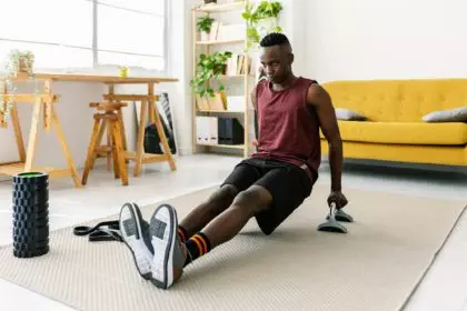 Young adult african man training at home